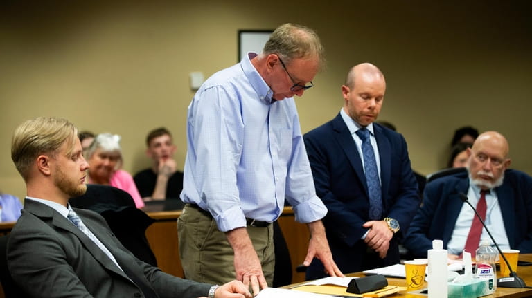 Michael Meyden, center left, who is accused of drugging his...