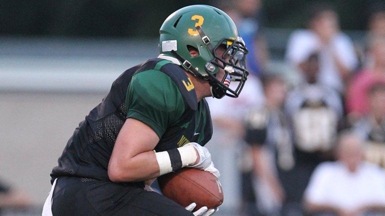 Ward Melville's Eddie Munoz (3) grabs a punt in the...