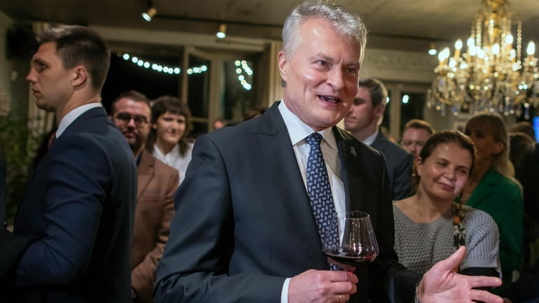 Lithuania's President Gitanas Nauseda, a presidential candidate, celebrates winning the...