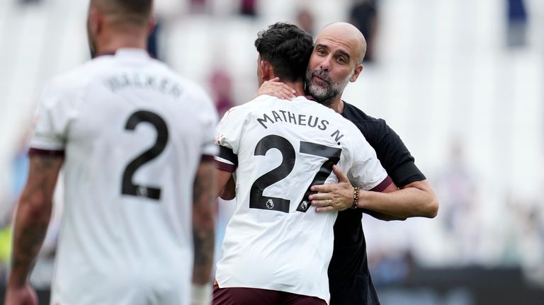 Manchester City's head coach Pep Guardiola celebrates with Manchester City's...