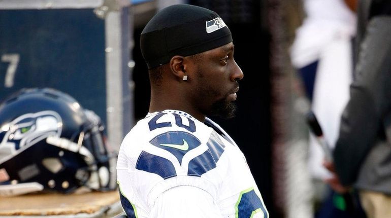 Seattle Seahawks cornerback Jeremy Lane sits as the national anthem...