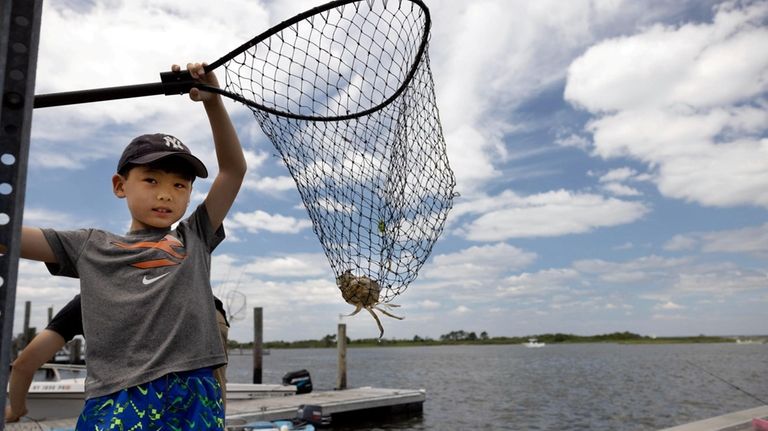 Taye Kim, 7, of Manhattan, fishing at Captree State Park...