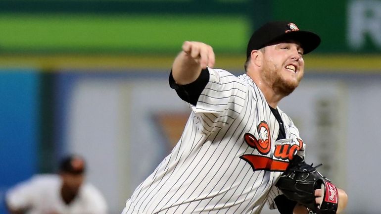 Long Island Ducks starting pitcher Matt Larkins delivers against the...