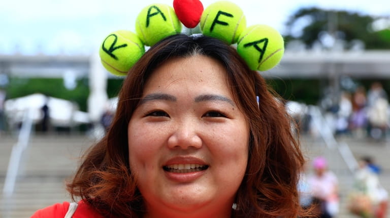 A fans of Spain's Rafael Nadal wears tennis balls with...