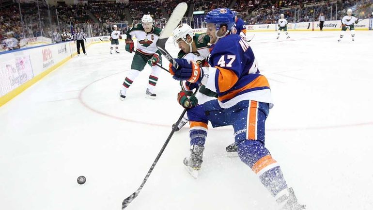 Andrew MacDonald #47 of the New York Islanders defends against...