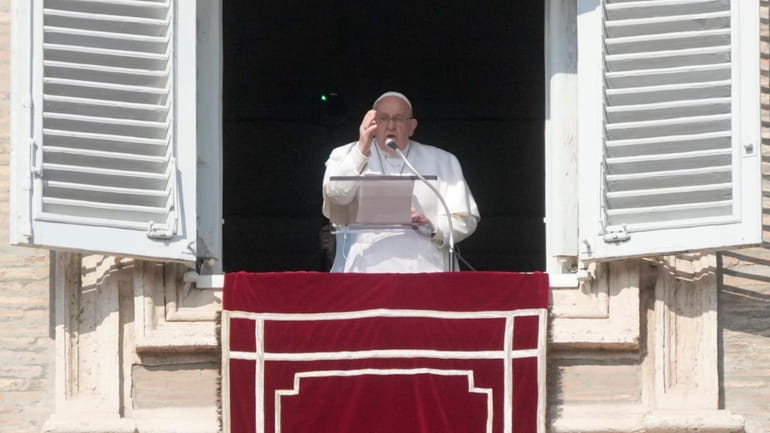 Pope Francis delivers the Angelus noon prayer in St. Peter's...
