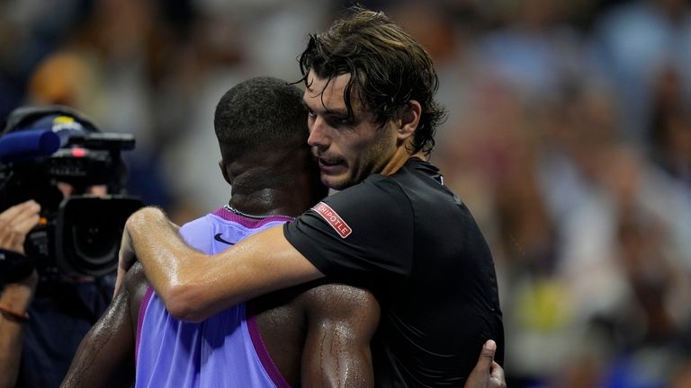 Taylor Fritz, of the United States, hugs Frances Tiafoe, of...