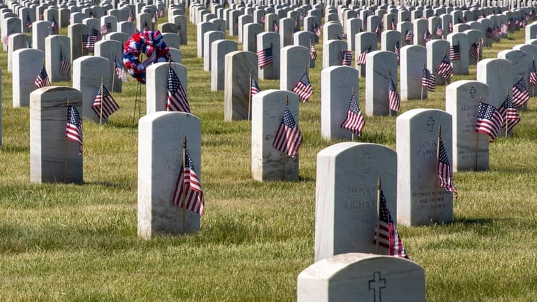 Flags on veterans' graves at Calverton National Cemetery on Memorial Day...