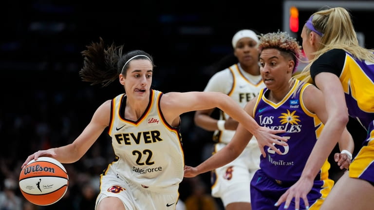 Indiana Fever guard Caitlin Clark (22) controls the ball against...