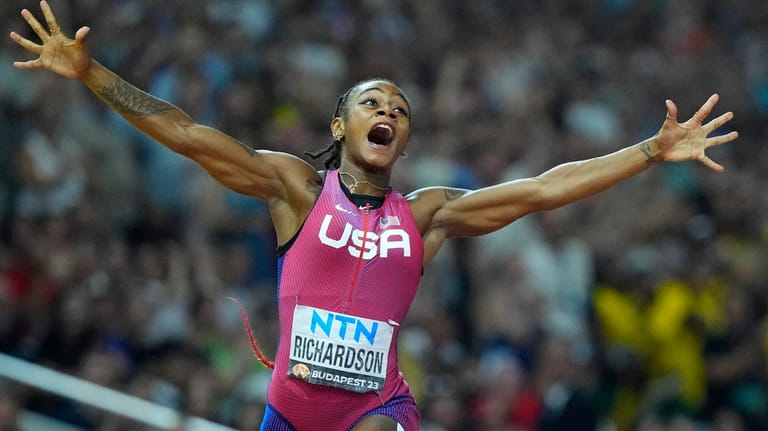Sha'Carri Richardson, of the United States, celebrates after winning the...