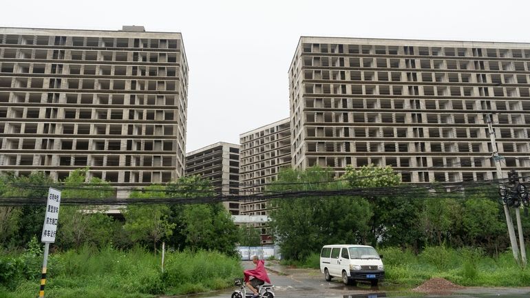 A rider passes by an abandoned construction project on the...