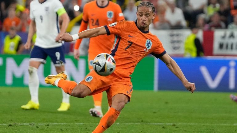 Xavi Simons of the Netherlands kicks a ball during a...