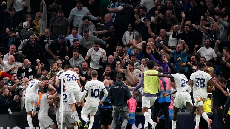 Players of Tottenham celebrate after Liverpool's Joel Matip scored an...