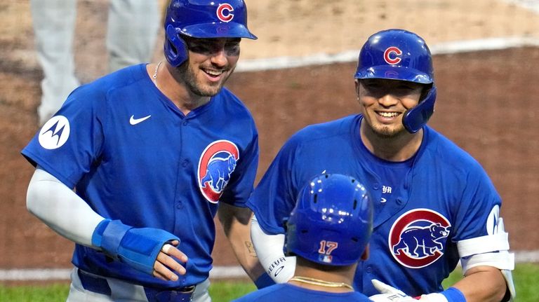 Chicago Cubs' Seiya Suzuki, right, celebrates with Mike Tauchman, left,...