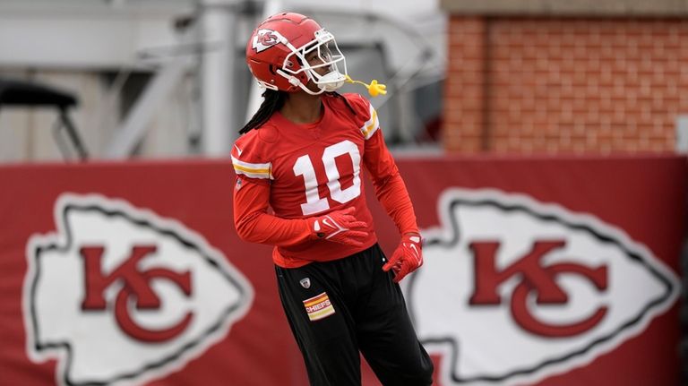 Kansas City Chiefs running back Isiah Pacheco stretches during the...