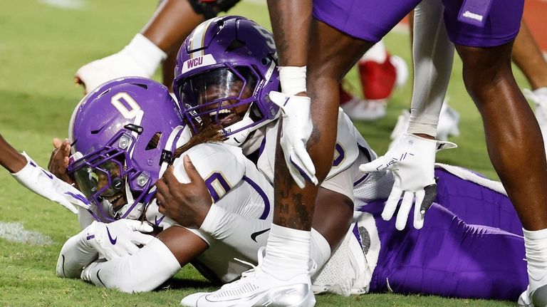 Western Carolina's Ken Moore Jr. (0) is celebrates his interception...