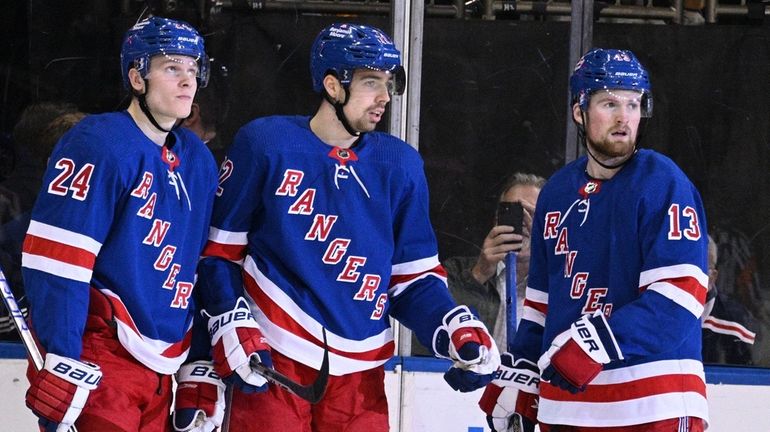 Rangers' Kaapo Kakko, Filip Chytil and Alexis Lafrenière look on...