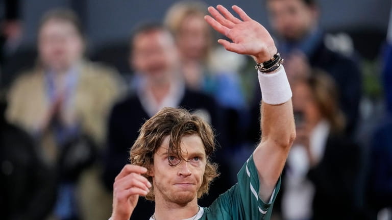 Andrey Rublev, of Russia, waves to the crowd after winning...