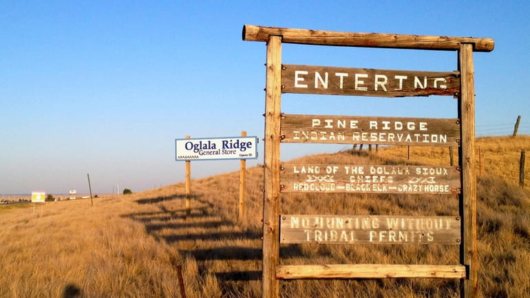 A sign hands outside the entrance to the Pine Ridge...
