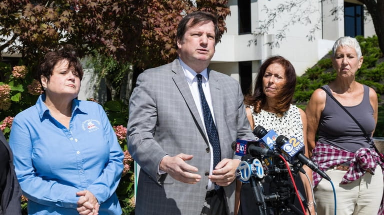 Attorney Christopher Murray, second from left, and Adrienne Esposito, second from...