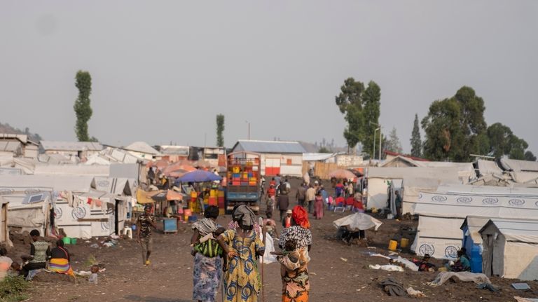 Women walk in the Bulengo refugee camp in Goma, Congo,...