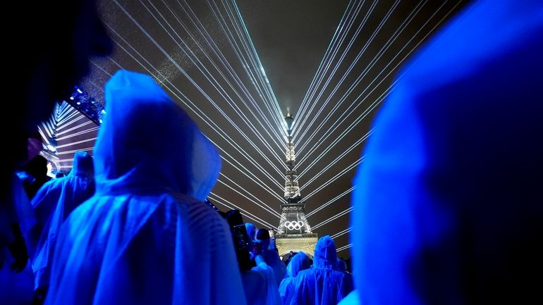 Flashes of lights illuminate the Eiffel Tower in Paris, France,...