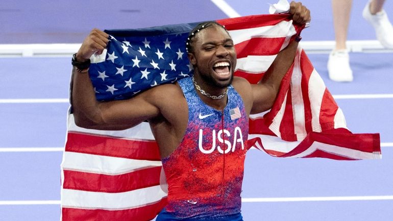 Noah Lyles, of the United States, celebrates after winning the...