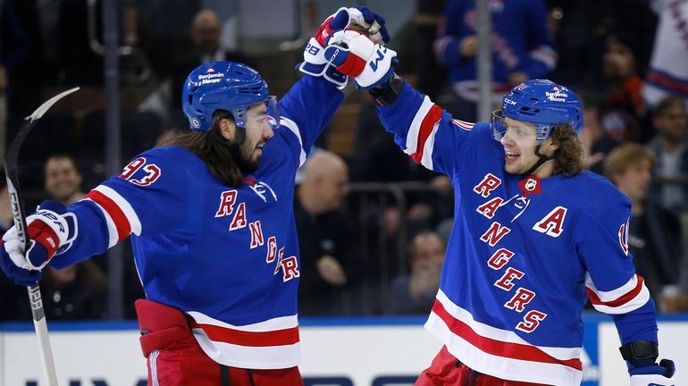 Rangers center Mika Zibanejad, left, congratulates Artemi Panarin after Panarin's...