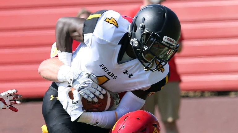 St. Anthony's Dion Williams gets hit during the CHSFL game...