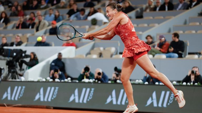 Aryna Sabalenka of Belarus plays a shot against Russia's Erika...