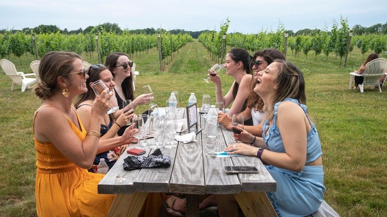 Friends taste wine at Bedell Cellars in Cutchogue.