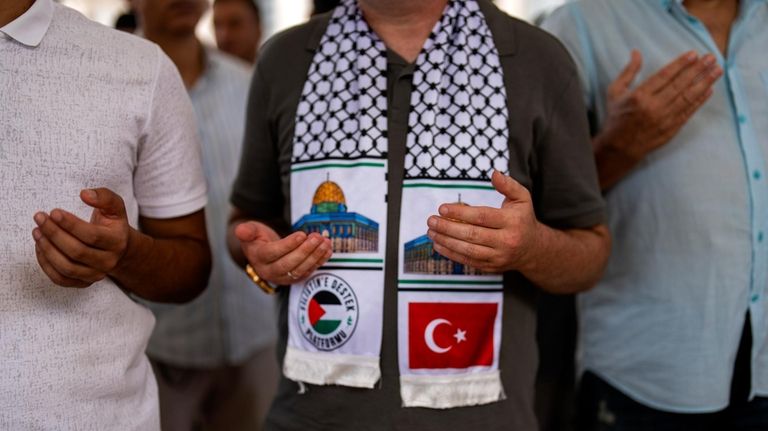 Men attend a funeral prayer in abstentia ceremony in memory...