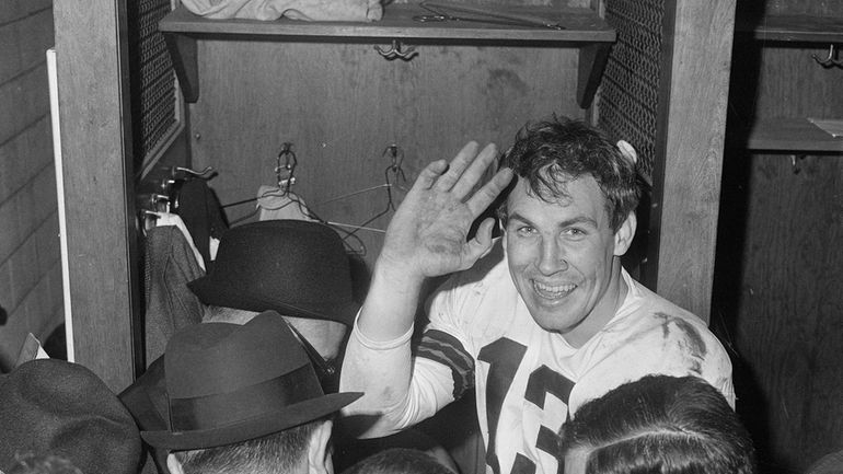 Cleveland Browns quarterback Frank Ryan gestures in the dressing room...