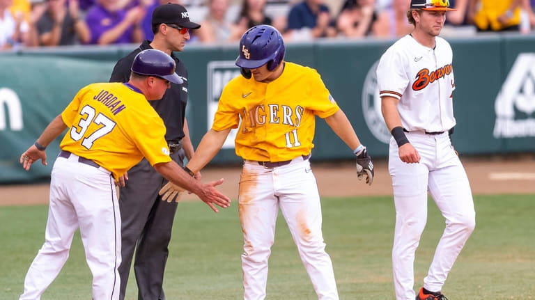 LSU's Josh Pearson (11) stands on third base during an...