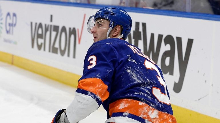 Adam Pelech #3 of the Islanders looks on after an injury...