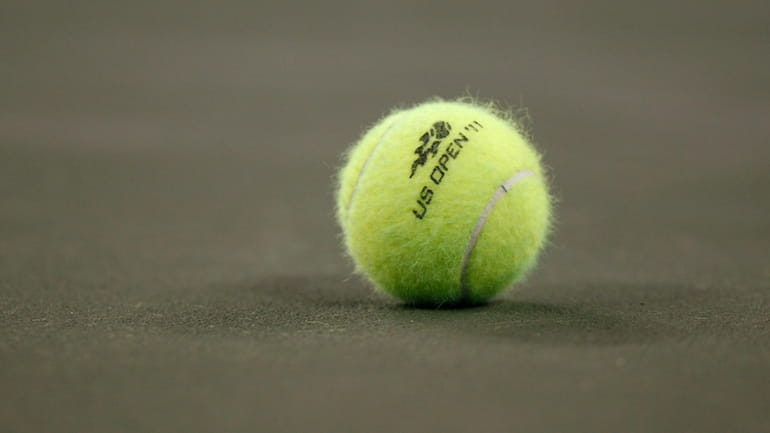 FILE = A tennis ball on the court during the...