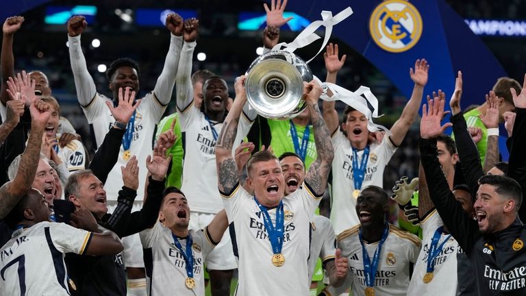 Real Madrid's Toni Kroos lifts the trophy after winning the...