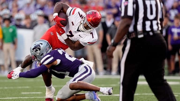 Arizona running back Quali Conley (7) dives over Kansas State...