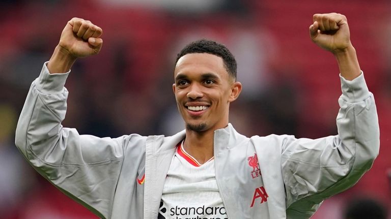 Liverpool's Trent Alexander-Arnold celebrates their victory at the English Premier...