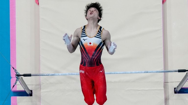 Takaaki Sugino of Japan performs on the horizontal bar during...