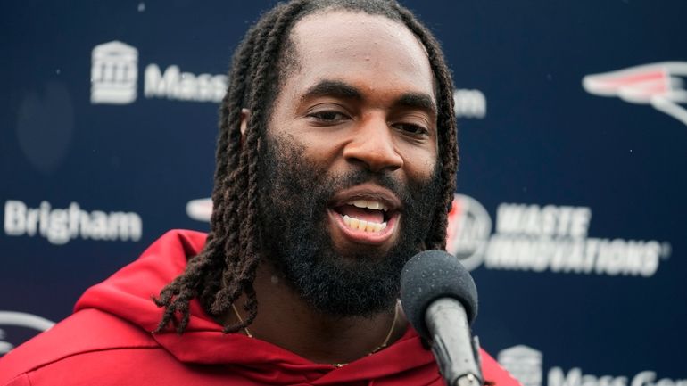 New England Patriots linebacker Matthew Judon speaks with reporters following...