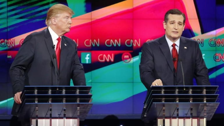 Ted Cruz, right, speaks as Donald Trump looks on during...
