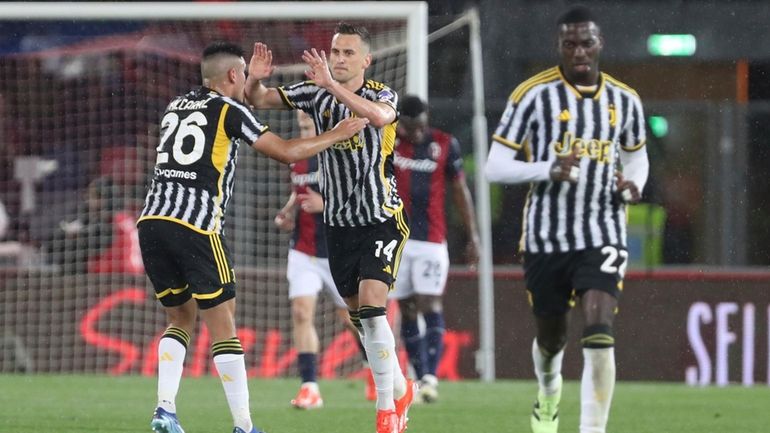 Juventus's Arkadiusz Milik, center, celebrates scoring during the Serie A...