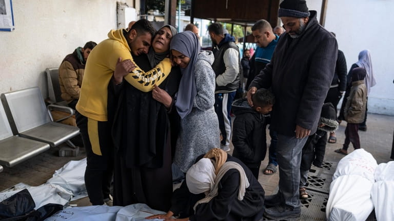 Palestinians mourn their relatives who were killed in the Israeli...