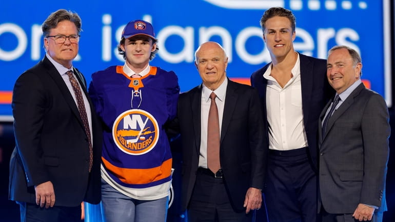 Cole Eiserman, second from left, poses after being selected by...