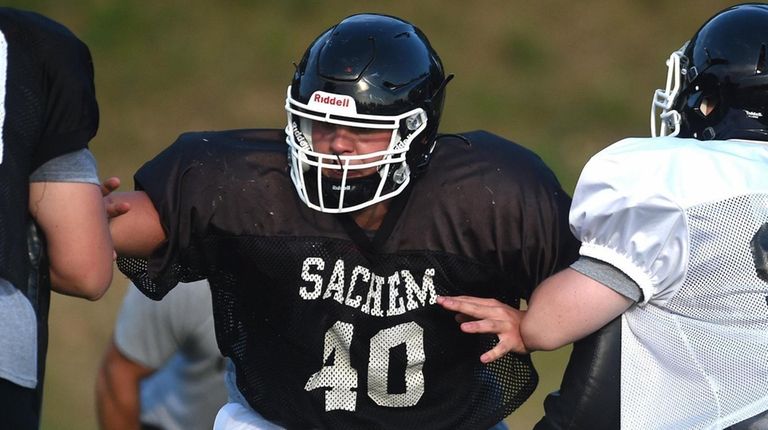 Sachem North lineman Joe Cruz, center, scrimmages with teammates on August...