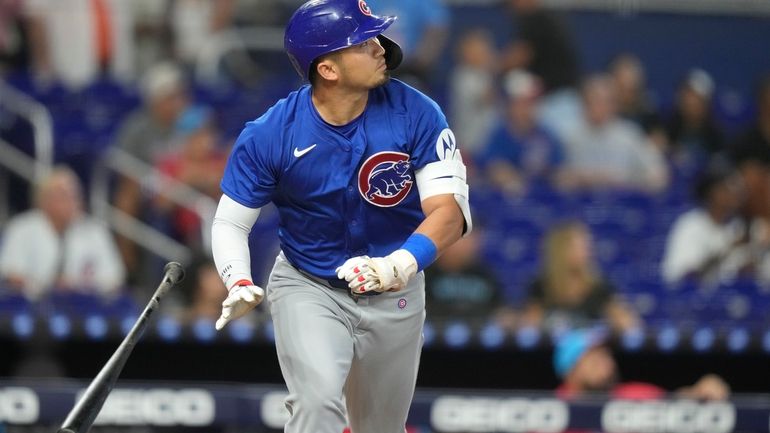 Chicago Cubs' Seiya Suzuki tosses his bat after hitting a...