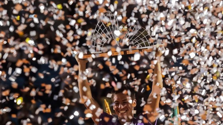 Sebastian Baez holds up his trophy after defeating Mariano Navone,...