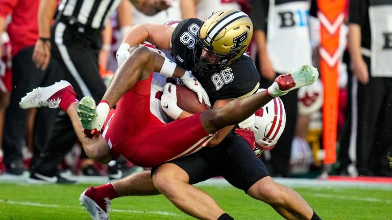 Wisconsin cornerback Jason Maitre (23) tackels Purdue tight end Max...