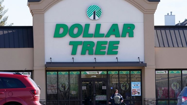 A woman leaves a Dollar Tree store in Urbandale, Iowa,...